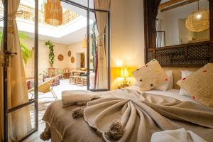 a bedroom with a large bed and a living room at Medina Sun in Marrakesh