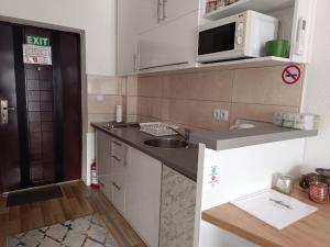 a small kitchen with a sink and a microwave at SWEET APT Zenica in Zenica