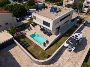an aerial view of a house with a swimming pool at Villa Privlaka Travertino in Privlaka
