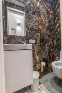 a bathroom with a sink and a mirror at varkiza luxury 2BD apartment in Varkiza +31 photos