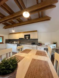 a large kitchen with a wooden table and chairs at Apartmán La Šiška - Věžička in Velké Karlovice