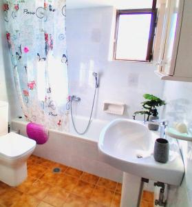 a bathroom with a shower and a sink and a toilet at Sea view house II in Dhílesi +37 photos