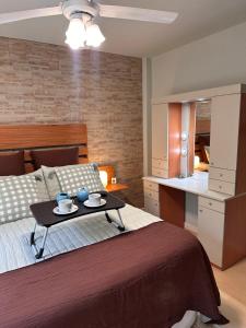 a bedroom with a bed with a table on it at Lysa Paraná in Paraná