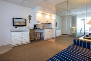 a kitchen with white cabinets and a counter top at Concord Suites in Avalon