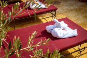 two white towels sitting on top of a red bench at Medina Sun in Marrakesh +119 photos
