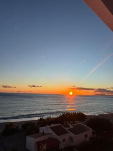 a sunset from the balcony of a condo at over the sea in El Morche +14 photos