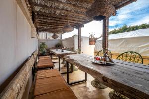 a patio with two tables and chairs and a wooden table at Medina Sun in Marrakesh