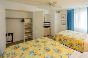 a bedroom with a bed and a television in it at Concord Suites in Avalon