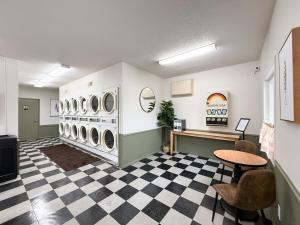 a laundry room with three washer and dryer machines at The Trail Inn - Grantsburg, WI - 703 WI-70 in Grantsburg