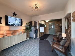 a living room with a couch and a television on a wall at The Trail Inn - Grantsburg, WI - 703 WI-70 in Grantsburg