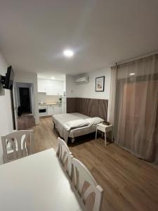 a bedroom with a bed and a table and chairs at Diplomatic Salou in Salou +19 photos