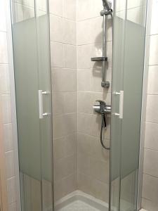a shower stall with a glass door and a shower at La Cachette Urbaine in Albi +15 photos