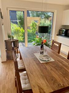 a dining room with a wooden table with chairs at Ferienwohnung Daudi in Bad Dürrheim