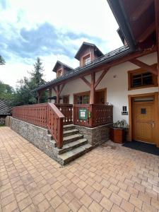 a house with a deck and stairs on it at Apartmán La Šiška - Věžička in Velké Karlovice