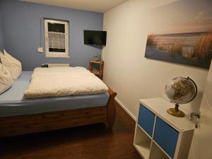 a bedroom with a bed and a window and a globe at Haus Margot in Katharinenberg