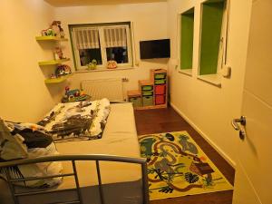 a small bedroom with a bed and a window at Haus Margot in Katharinenberg