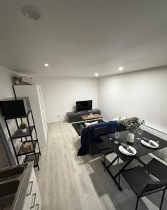 a living room with black chairs and a table at Geneve Gaillard studio in Gaillard