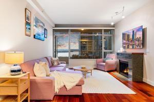 a living room with a purple couch and a fireplace at Electra Building 2bed - Views Pool Sauna Spa in San Diego