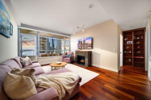 a living room with a couch and a fireplace at Electra Building 2bed - Views Pool Sauna Spa in San Diego