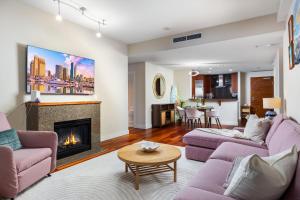 a living room with purple furniture and a fireplace at Electra Building 2bed - Views Pool Sauna Spa in San Diego +46 photos