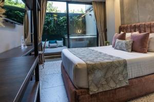 a bedroom with a bed and a large window at The O by Seekers Medellín in Medellín