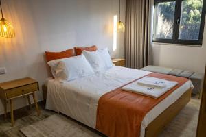 a hotel room with a bed with a tray on it at Casa Da Eira Caramulo in Varzielas +31 photos