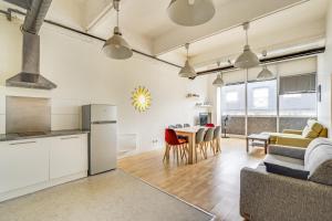 a kitchen and living room with a couch and a table at Les LILAS in Les Lilas