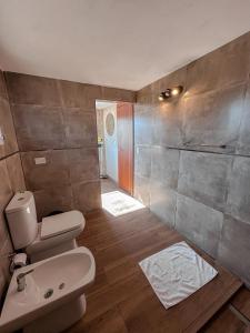 a bathroom with a toilet and a sink in it at DelViento Cabañas in Las Rabonas +31 photos