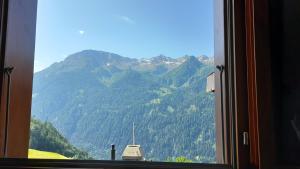 a window with a view of a mountain at Chalet del Sole in Quinto