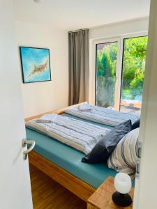 a bed in a room with a window at Ferienwohnung Daudi in Bad Dürrheim