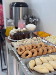 a table with different types of donuts and other pastries at Hotel Tropical in Torres