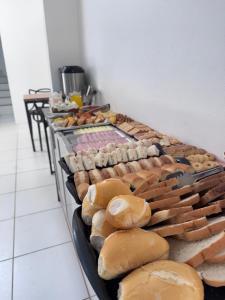 a bunch of breads and pastries on display in a bakery at Hotel Tropical in Torres