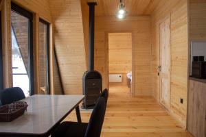 a dining room with a table and a woodburning stove at Panorama Mazeri in Tvebishi