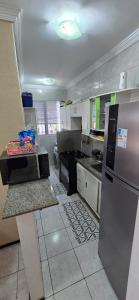 a kitchen with a stainless steel refrigerator and appliances at Tesouro da Maraponga in Fortaleza