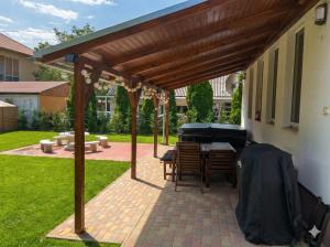 a patio with awning and a table and a piano at Zora's apartment in Siófok