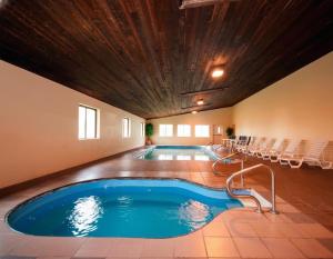 a pool in a hotel room with chairs around it at Quality Inn Milan-Sandusky in Milan
