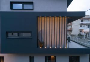 a black and white building with a large window at Kalvokoresi 16 I Premium Apartments in Chios