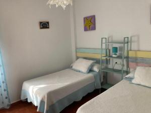 a room with two beds in a room at Casa Rural Kentia in Valdepeñas +18 photos