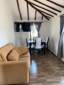 a living room with a couch and a table at Hotel Arcoiris Mesa de los Santos in Los Santos