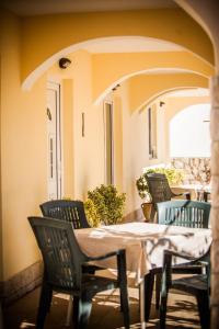 a patio with a table and chairs on a porch at Apartments Skapul in Lopar