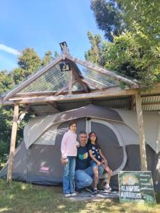 a group of people standing inside of a tent at Glamping Mañihueico in Contao +7 photos