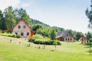 two barns and a play yard with a playground at Resort Malevil in Jablonné v Podještědí