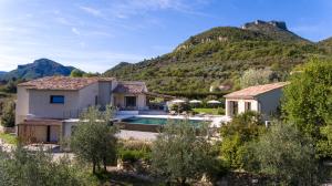 a house with a swimming pool in front of a mountain at La Grange de Fer - Maison de caractère piscine privée in Saint-Ferréol-Trente-Pas +30 photos