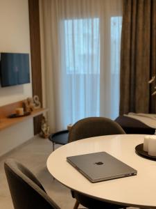 a laptop sitting on top of a table in a room at AuRa The Golden Suite in Alexandroupoli