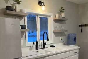 a kitchen with a sink and a window at Heron Cottage on Cayuga Lake in Aurora +48 photos