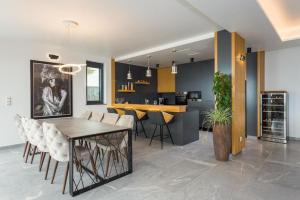 a dining room and kitchen with a table and chairs at Villa Titanium in Opatija
