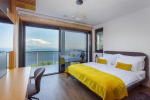 a bedroom with a bed and a table with a yellow blanket at Villa Titanium in Opatija +34 photos