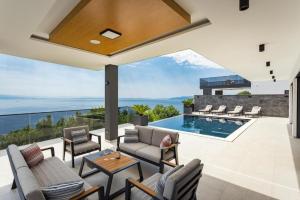 an indoor patio with a view of the ocean at Villa Titanium in Opatija