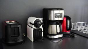 a coffee maker and coffeemaker sitting on a counter at MOOREA - Waterfall Pool Coconut House 1 in Pihaena