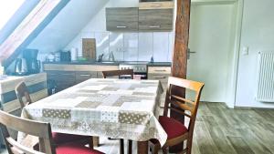 a kitchen with a table and chairs in a room at Pension Bernburg A² in Bernburg